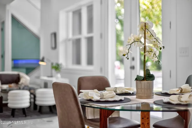 a dining room with furniture and window