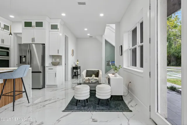 a kitchen with stainless steel appliances granite countertop a refrigerator and a stove top oven