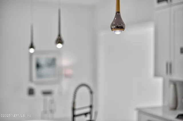 a living room with furniture and floor to ceiling windows