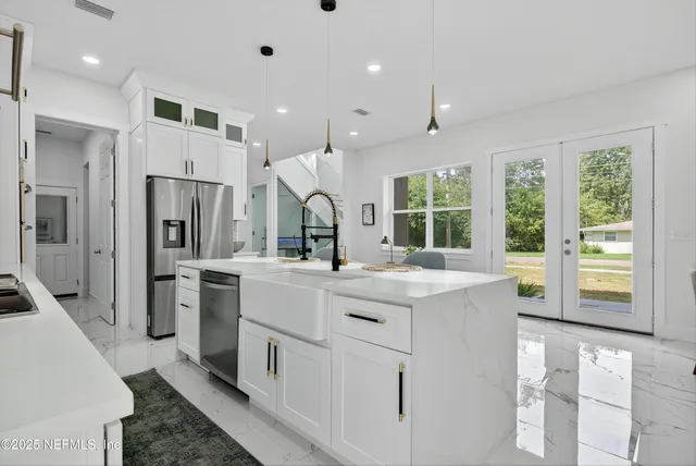 a spacious bedroom with a bed and a chandelier