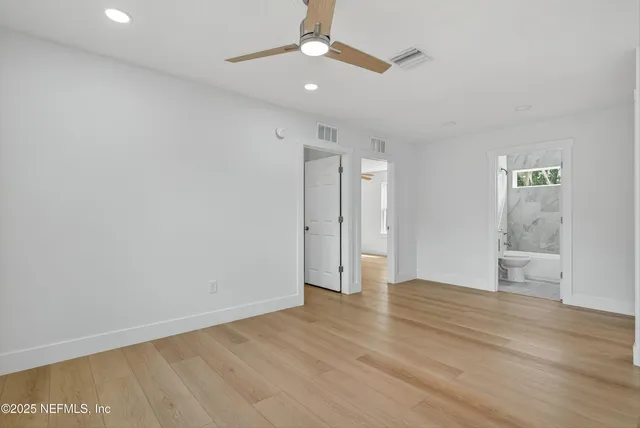 a view of a house with a yard and a large tree