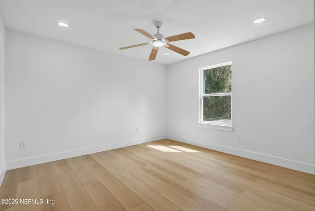 a white house that has a tree in front of it