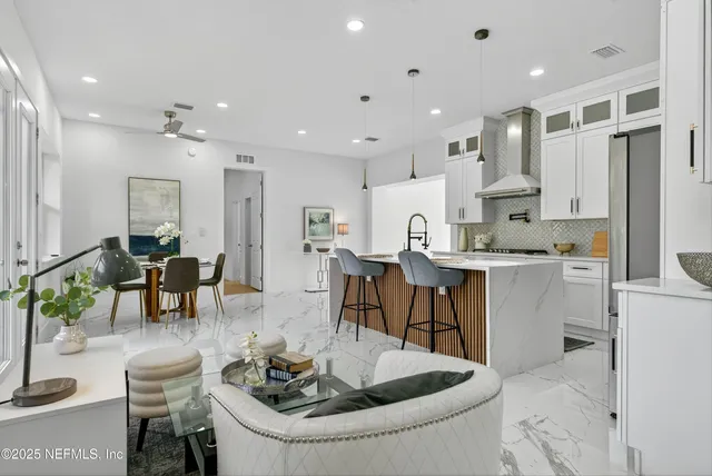 a living room with furniture and large windows