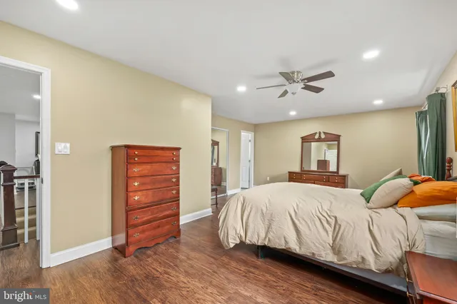 a bedroom with a bed and a ceiling fan