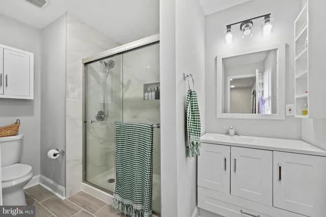 a bathroom with a toilet sink shower and mirror