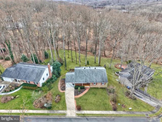 an aerial view of a house with a yard and outdoor seating