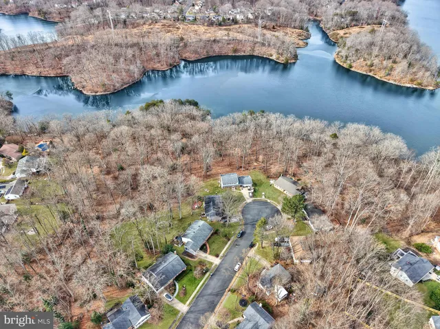 an aerial view of residential house with outdoor space and lake view