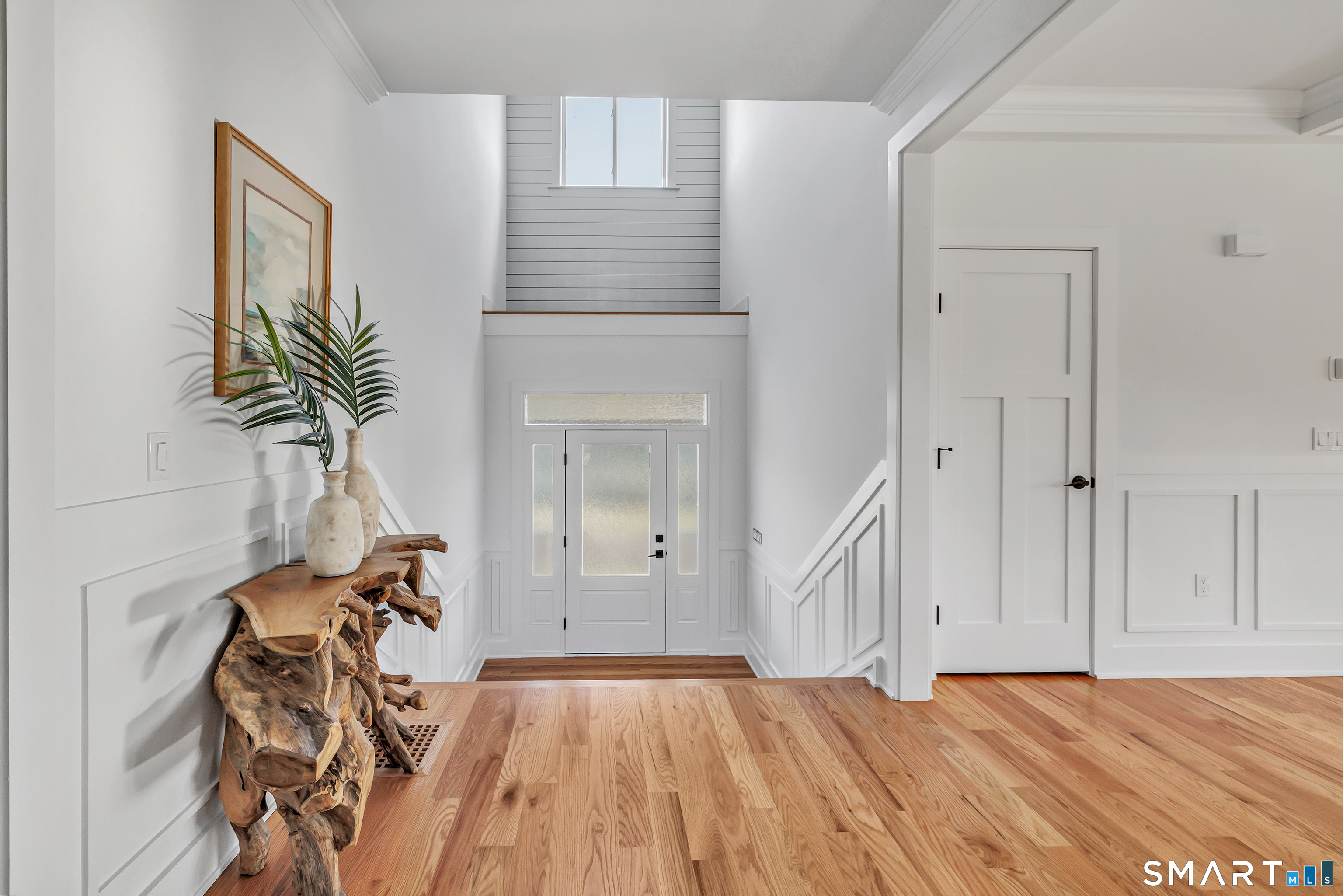 212 Milford Point Road Milford, CT 06460 - Photo 8 of 40 a view of empty room with window and wooden floor