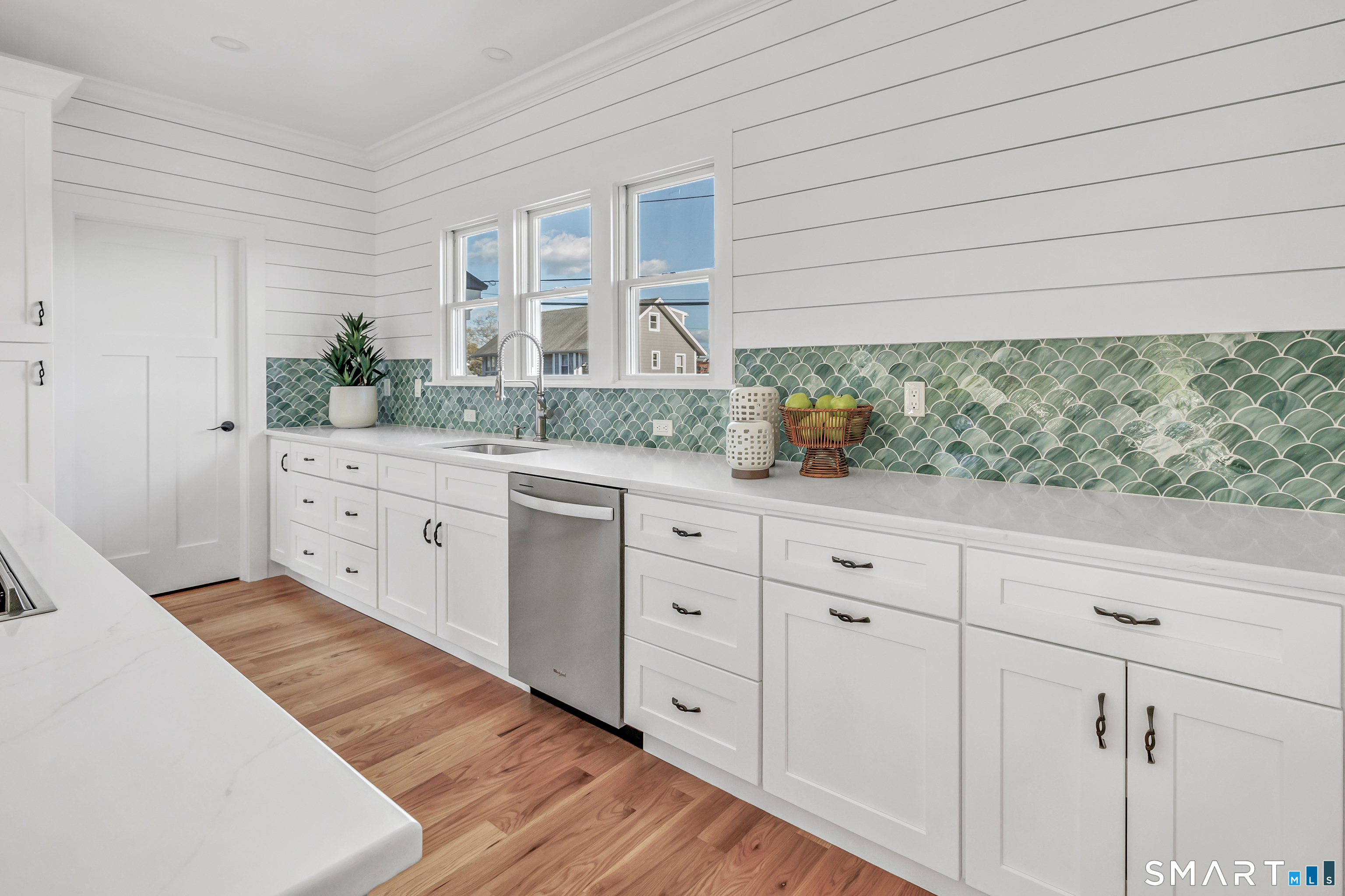 212 Milford Point Road Milford, CT 06460 - Photo 12 of 40 a spacious bathroom with a granite countertop sink and a large mirror