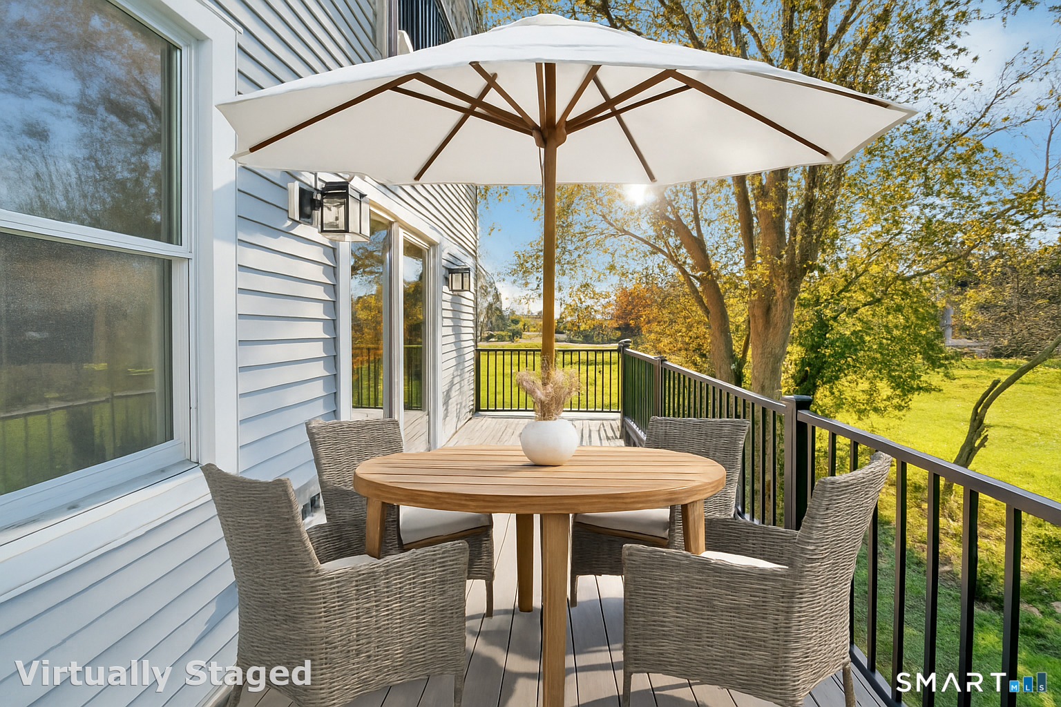 212 Milford Point Road Milford, CT 06460 - Photo 15 of 40 a view of a patio with a table and chairs under an umbrella