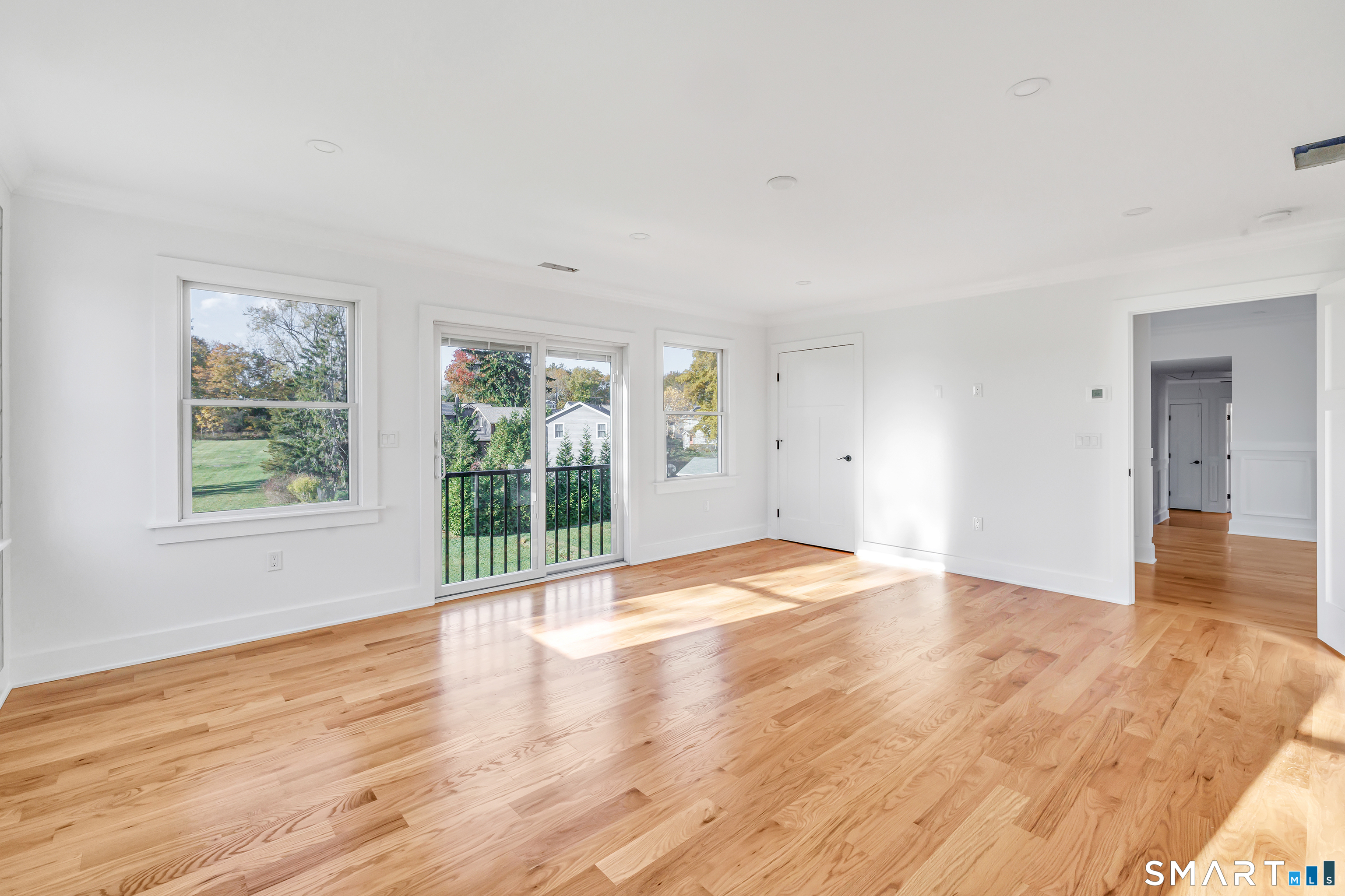 212 Milford Point Road Milford, CT 06460 - Photo 24 of 40 an empty room with wooden floor and windows