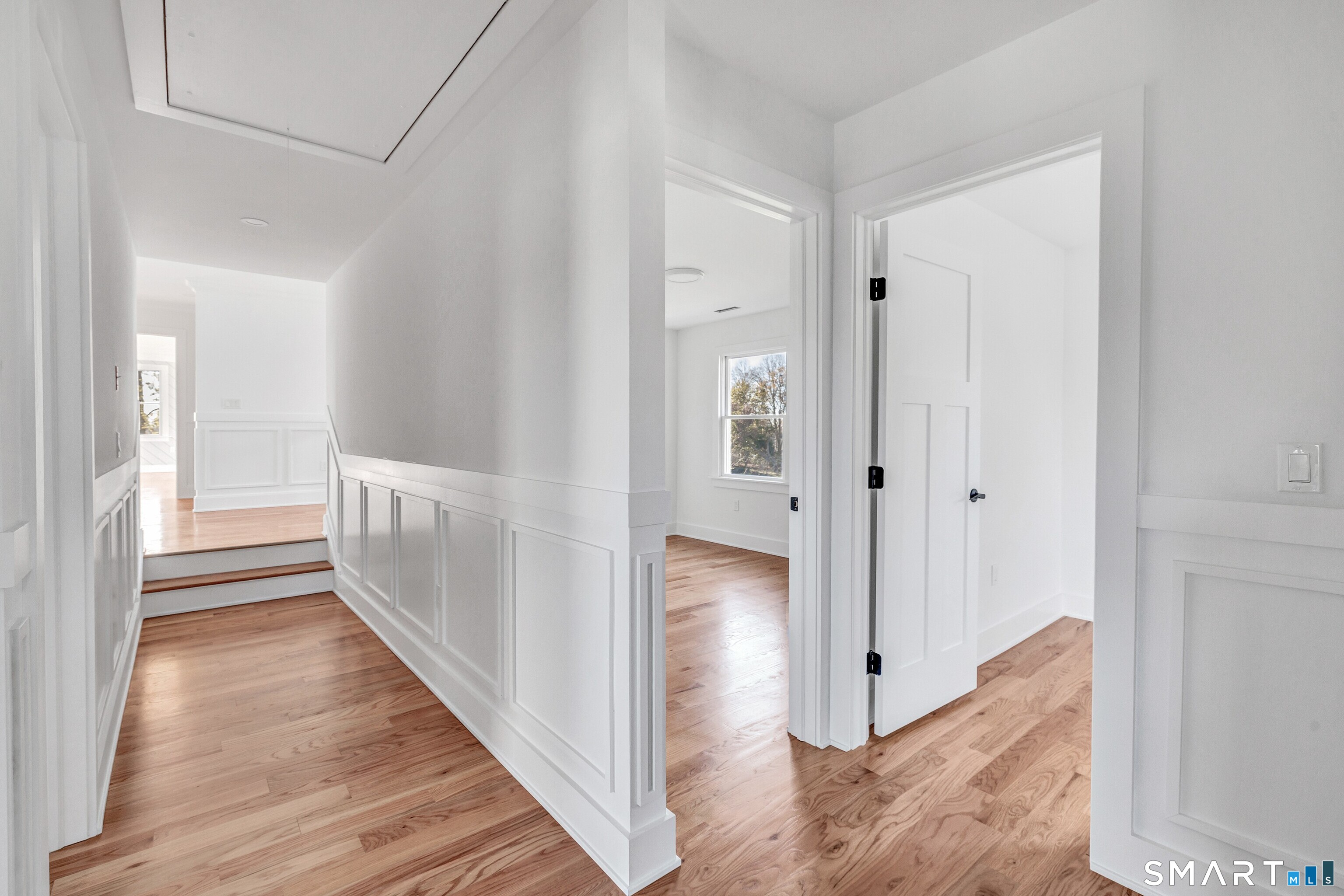 212 Milford Point Road Milford, CT 06460 - Photo 27 of 40 a view of a hallway with wooden floor