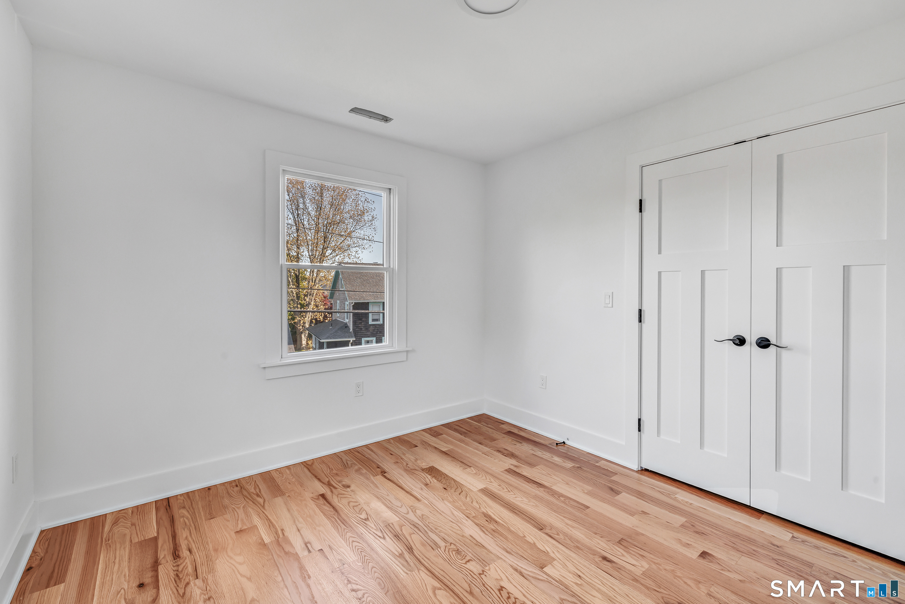 212 Milford Point Road Milford, CT 06460 - Photo 29 of 40 a view of empty room with wooden floor and fan