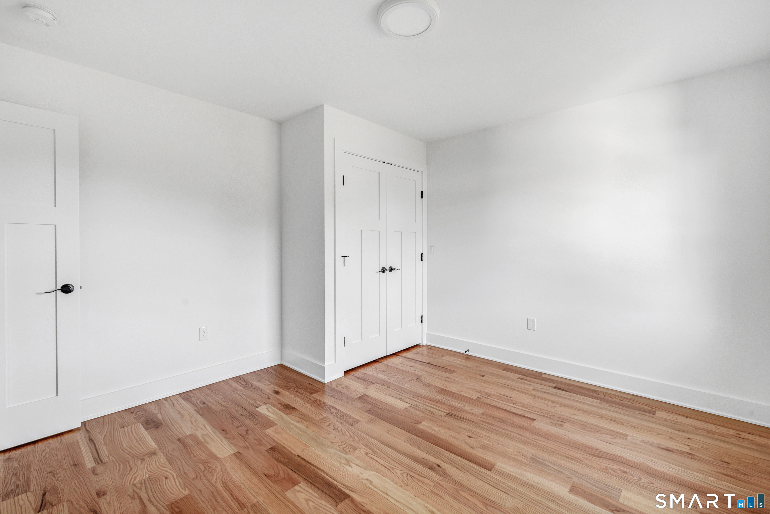 212 Milford Point Road Milford, CT 06460 - Photo 32 of 40 a view of empty room with wooden floor