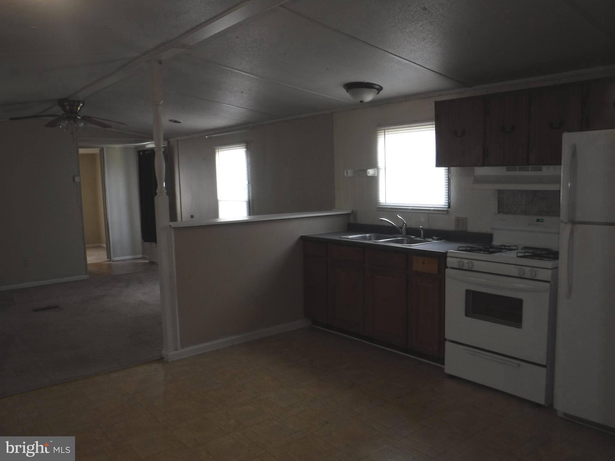 47 Shamrock Avenue Dover, DE 19901 - Photo 6 of 13 a kitchen with granite countertop a stove and a refrigerator