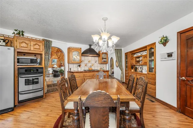 a view of a dining room with furniture wooden floor and chandelier