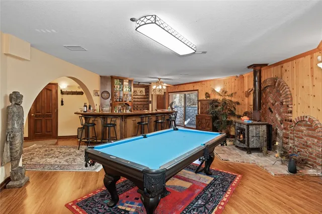 a room with pool table and windows