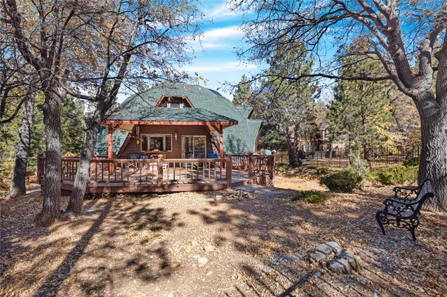 a view of house with deck and outdoor seating