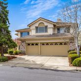 a view of a house with a yard and garage