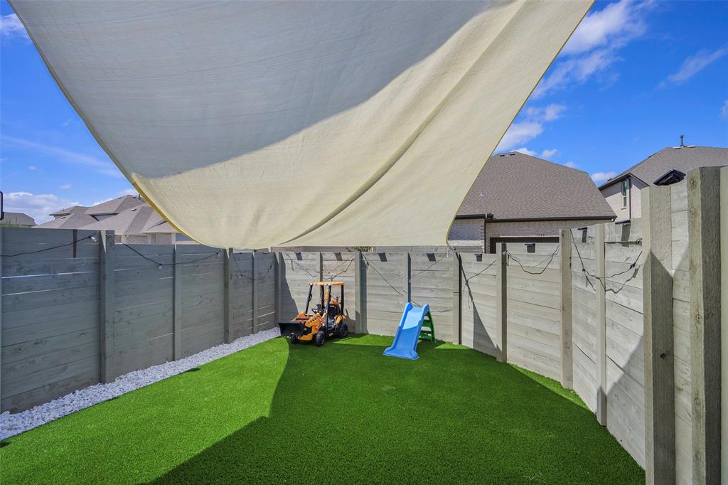 3603 Scotsman Road Sachse, TX 75048 - Photo 5 of 33 a view of a backyard with table and chairs under an umbrella