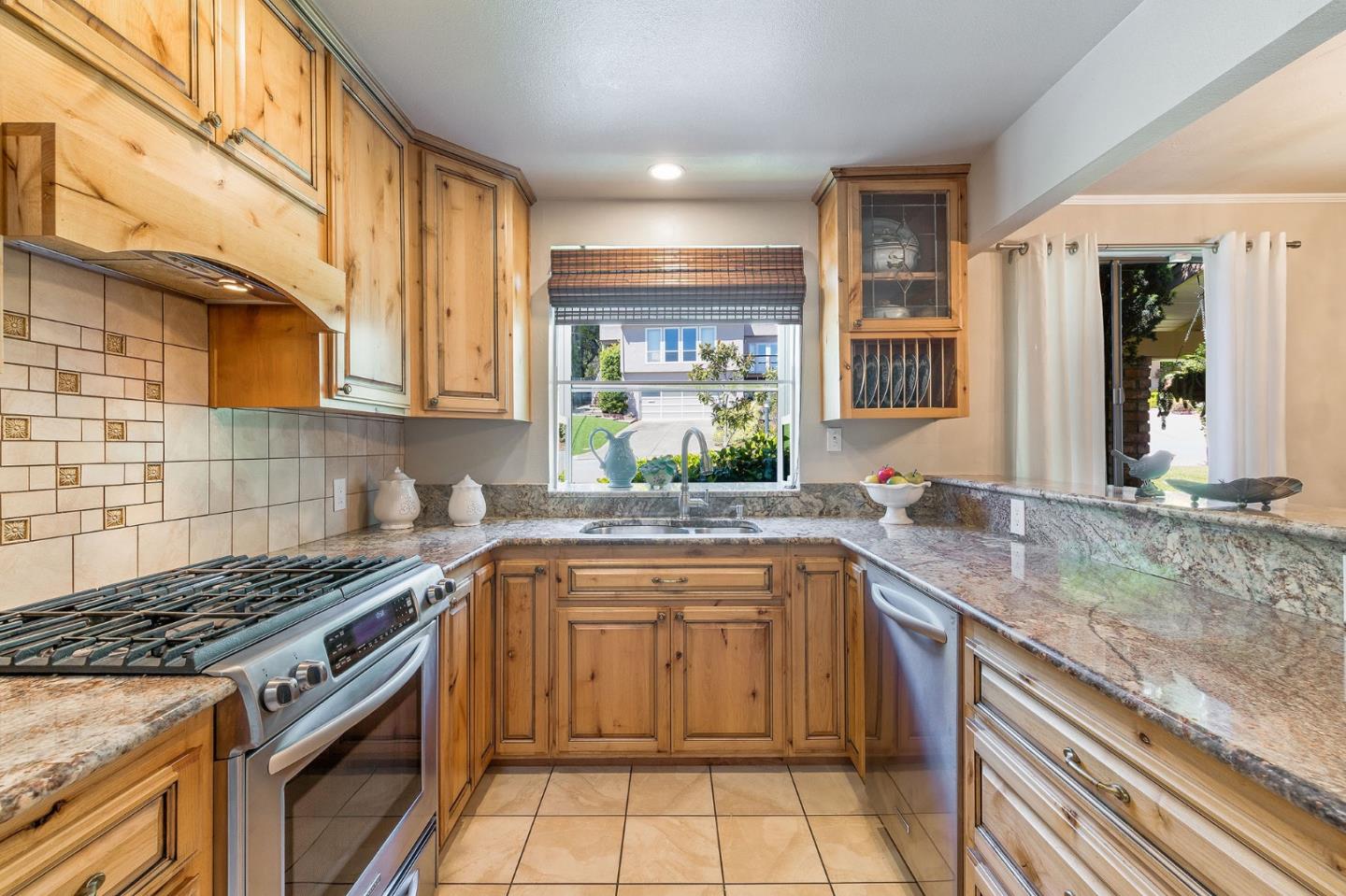 120 La Prenda Millbrae, CA 94030 - Photo 17 of 43 a kitchen with a sink stove and cabinets