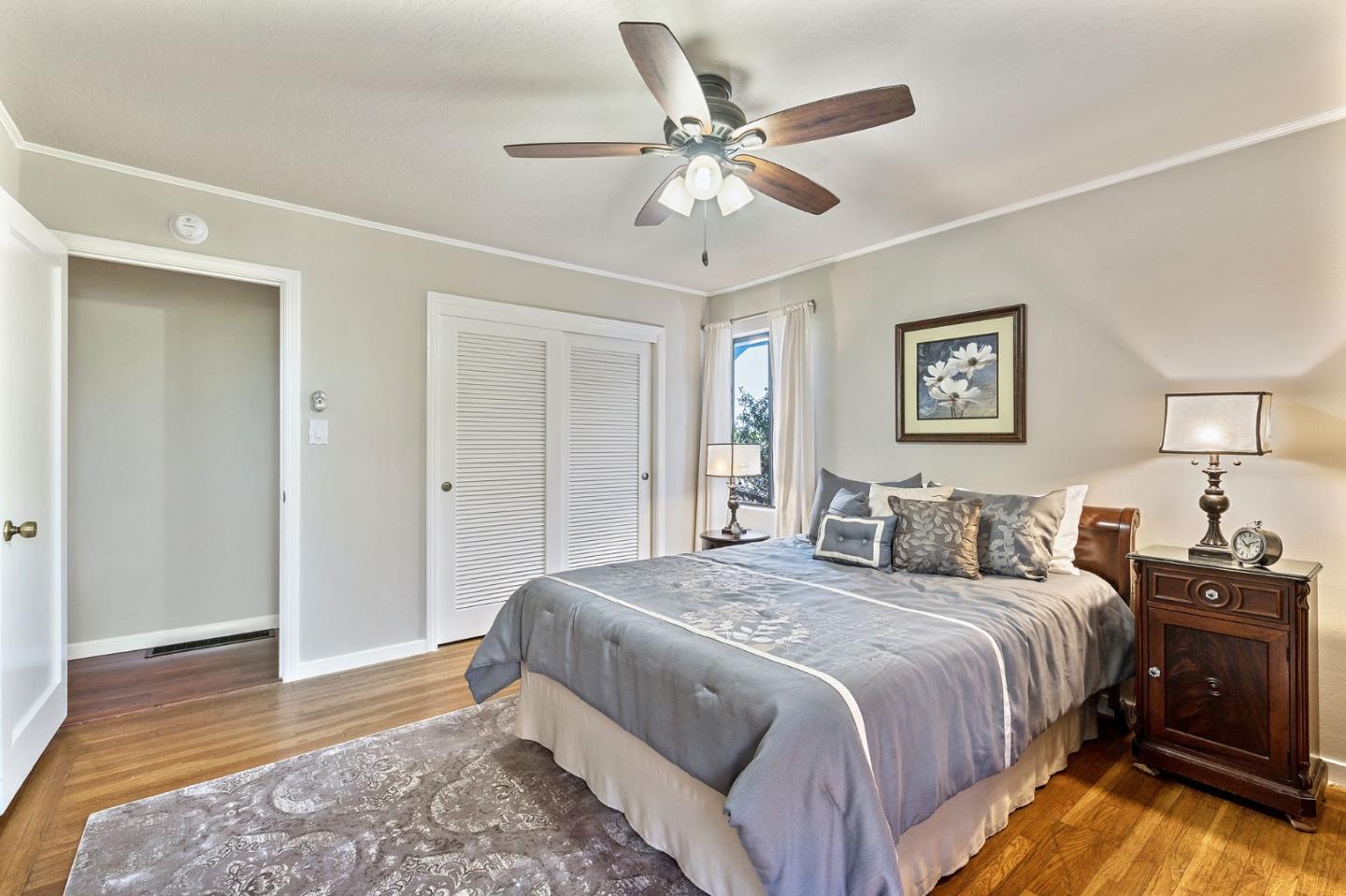 120 La Prenda Millbrae, CA 94030 - Photo 24 of 43 a bedroom with a large bed and a chandelier