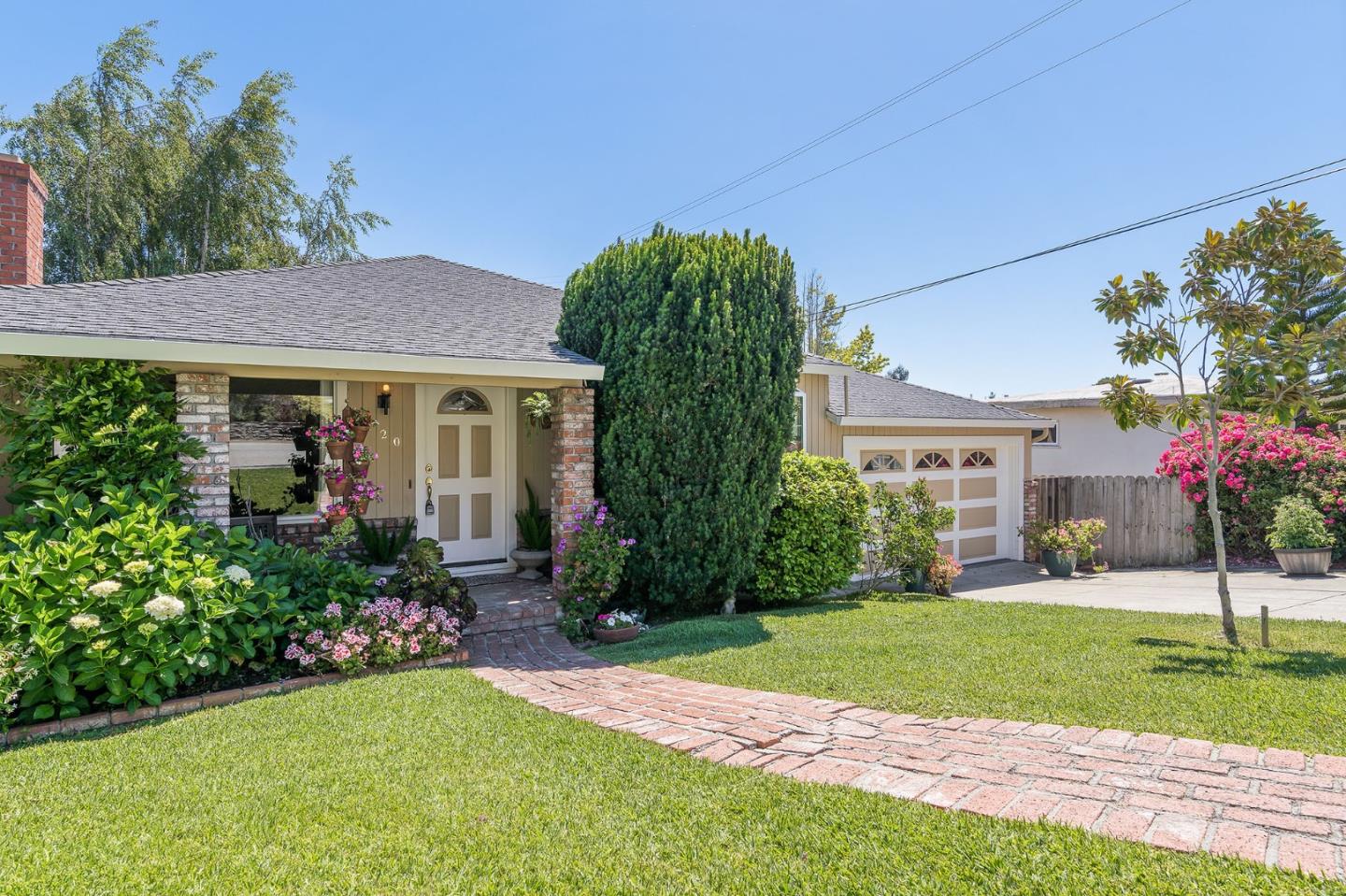 120 La Prenda Millbrae, CA 94030 - Photo 3 of 43 a front view of a house with a yard and potted plants