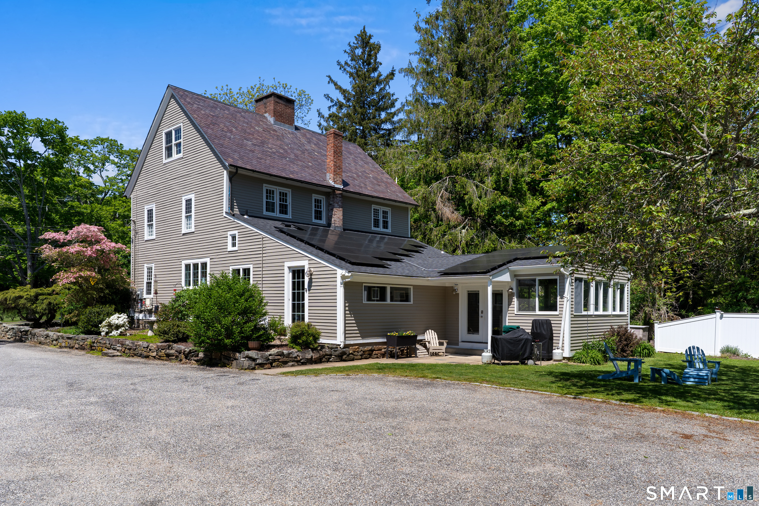 147 Boston Street Guilford, CT 06437 - Photo 5 of 38 a front view of a house with a yard and garage