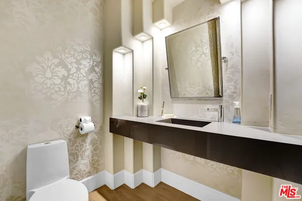 a large bathroom with a double vanity sink a mirror and a