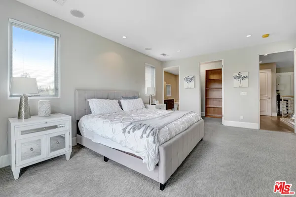 a bedroom with bed and a window