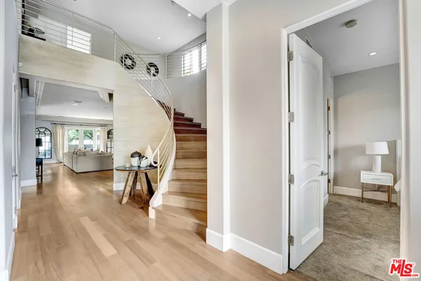 a view of entryway and hall with wooden floor