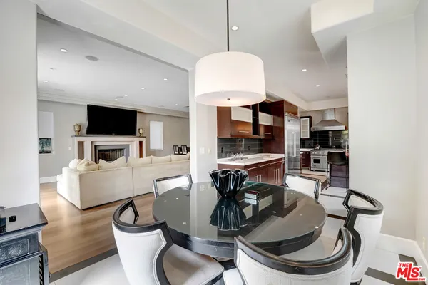 a kitchen with a sink a counter and chairs