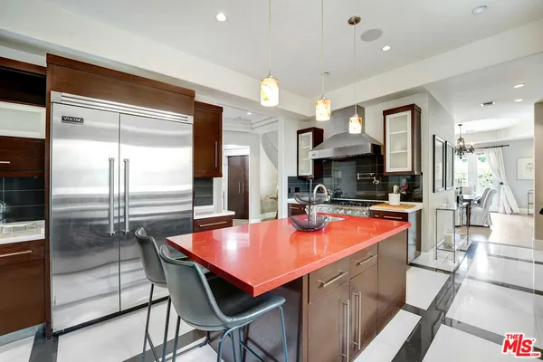 a kitchen with stainless steel appliances granite countertop wooden cabinets and sink