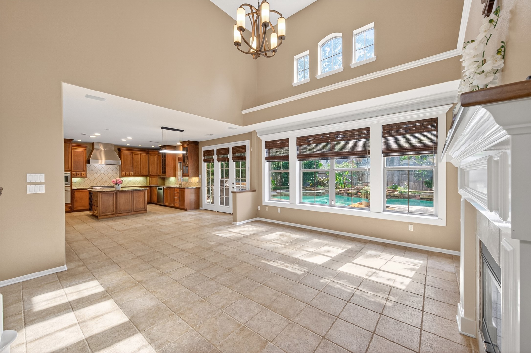 10 Mirror Ridge Drive The Woodlands, TX 77382 - Photo 12 of 48 Living room features two story soaring ceilings and open concept layout with views to the backyard swimming pool