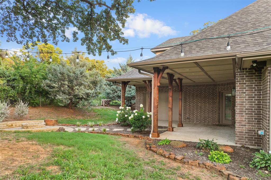 124 Garza Road Shady Shores, TX 76208 - Photo 32 of 40 Large covered patio and stone fire pit sitting area