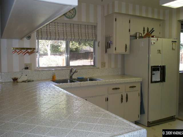 1325 Tapadero Trail Reno, NV 89521 - Photo 3 of 9 a bathroom with a granite countertop sink a toilet and shower