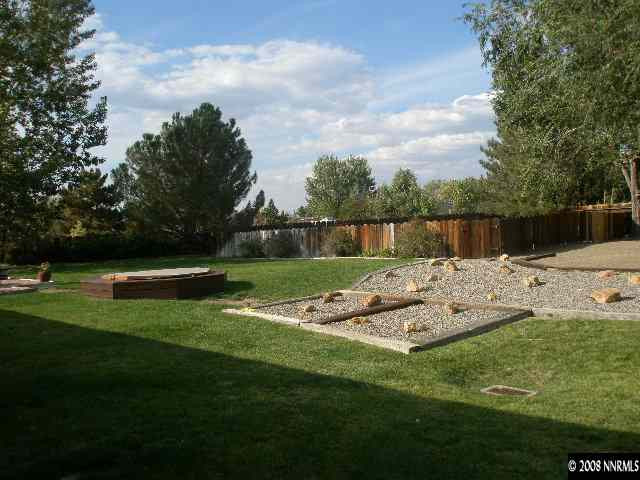 1325 Tapadero Trail Reno, NV 89521 - Photo 8 of 9 a view of house with swimming pool and garden