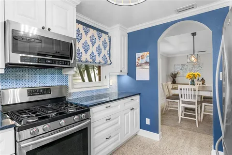 a kitchen with stainless steel appliances a stove a microwave and cabinets