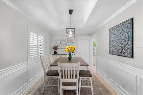 a dining room with furniture window and outside view