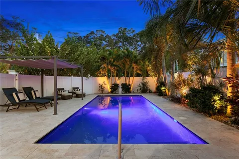 a view of a swimming pool with chairs in patio