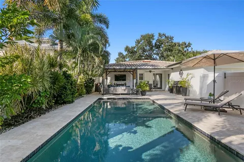 a view of a house with swimming pool and sitting area