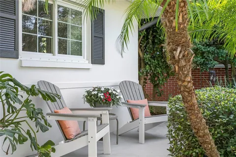 a view of a house with a chairs and table in a patio