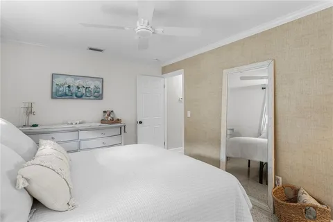 a bedroom with a bed and a painting on the wall