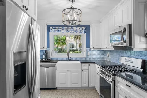 a kitchen with a stove a sink and a refrigerator