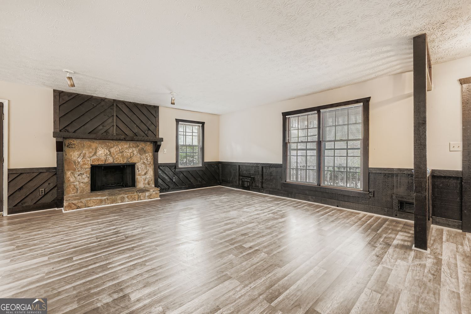 2932 Marsh Lane Southwest Stone Mountain, GA 30087 - Photo 2 of 11 a view of empty room with wooden floor and fireplace