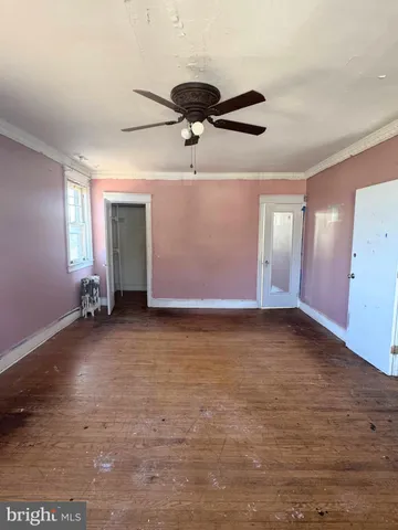 a view of a livingroom with a ceiling fan and window