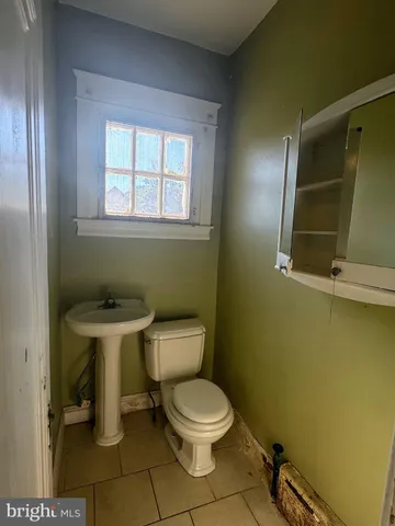 a white toilet sitting next to a bathroom sink