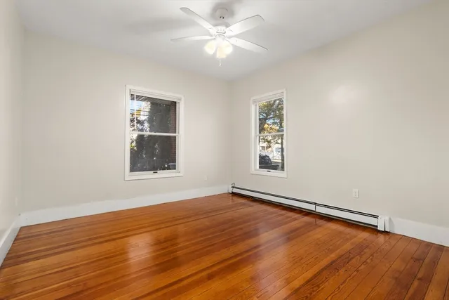 wooden floor in an empty room with a window