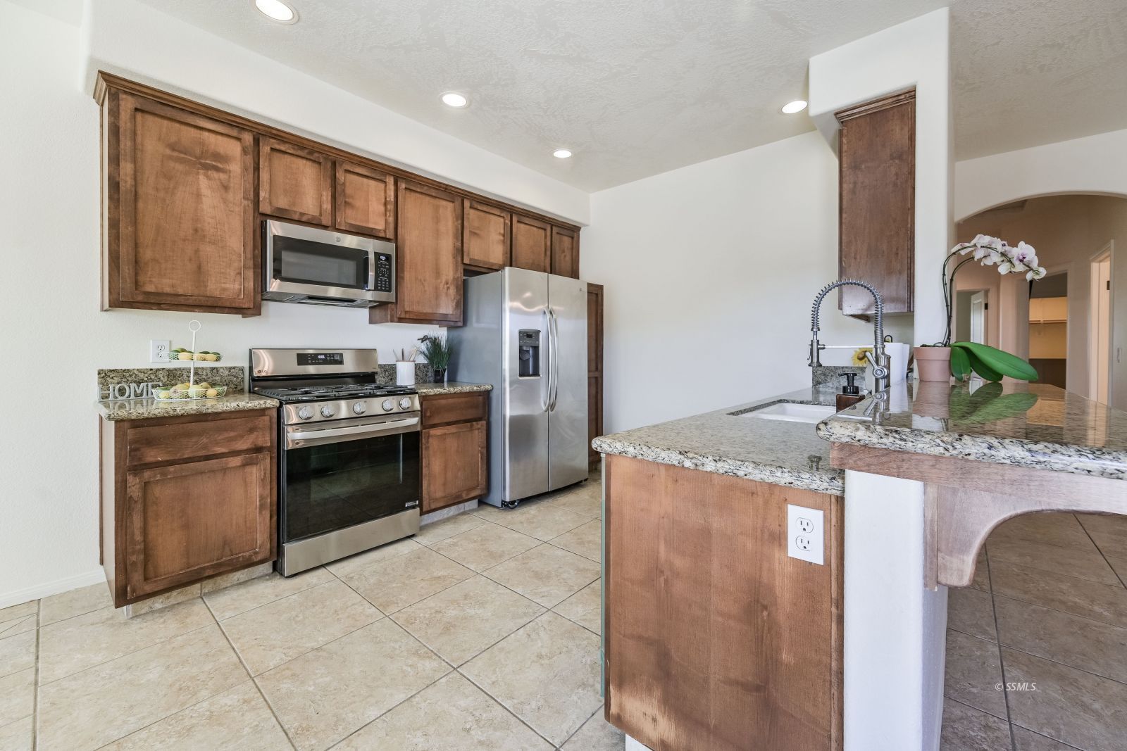 320 South Inyo Street Ridgecrest, CA 93555 - Photo 19 of 42 a kitchen with stainless steel appliances granite countertop a stove refrigerator sink and microwave
