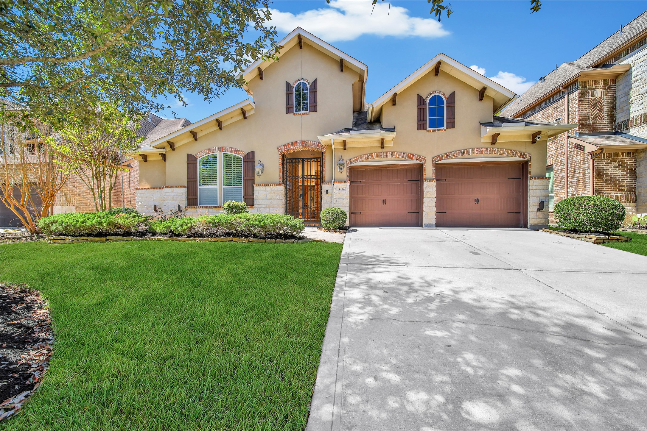3234 Explorer Way Conroe, TX 77301 - Photo 4 of 46 Beautifully crafted exterior with timeless architecture, manicured landscaping, and a spacious 3-car garage with workshop area!